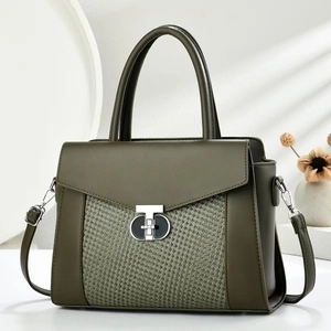 Olive green shoulder bag with woven leather panel and silver T-lock in a soft studio setting