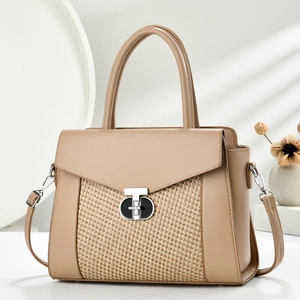 Detail of minimalist leather and woven patchwork shoulder bag with silver T-lock buckle