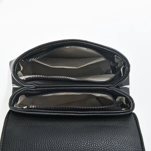 Top view of black lychee leather handbag interior with dual zippers and multi-compartments