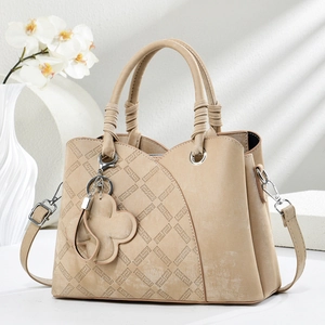 Chic beige shoulder handbag with diamond lattice stitching and floral charm accessory