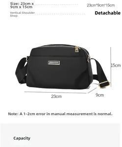 Detailed view of black crossbody bag dimensions 23x9x15cm with detachable strap