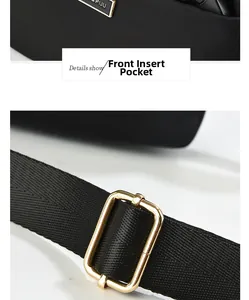Detail of black nylon shoulder bag showing front pocket and golden adjustment buckle