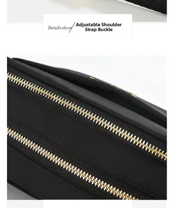 Detailed close-up of premium gold zippers and adjustable strap buckle on a black nylon bag