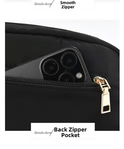 Detail of the back zipper pocket on a black bag holding a smartphone for scale