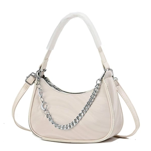 Chic beige crescent shoulder bag with decorative silver metal chain and moon charm