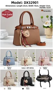 Detail view of woven texture handbag with plush bear charm and adjustable shoulder strap