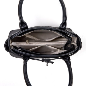 Interior view of large black tote bag featuring multiple compartments and herringbone lining