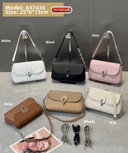 Detail view of woven flap texture and metal clasp on crossbody box bags in multiple colors
