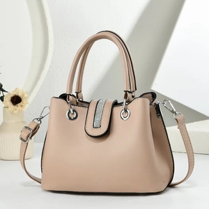 Elegant beige leather handbag with silver sequin detail and adjustable strap