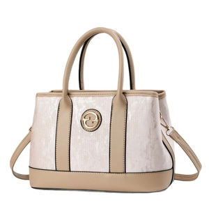 Chic textured cream handbag with camel leather trim and gold metal logo, front view