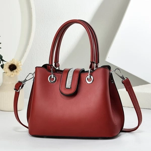 Close-up of deep red leather handbag with vertical rhinestone bar and silver ring detail