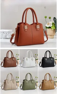 Detailed view of the luxury lychee grain leather texture and metallic buckle on the handbag