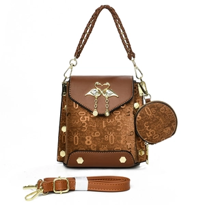 Fashionable brown faux leather handbag with embossed numbers and a gold swan clasp