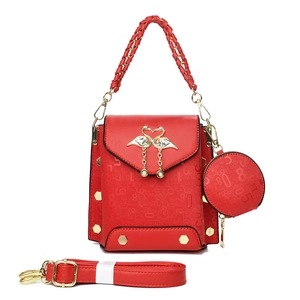 Red embossed faux leather tote bag with swan pendant and matching round coin purse