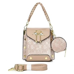 Detail view of beige crossbody bag set with swan buckle and mini round coin purse