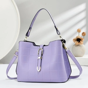 Close-up of lavender leather shoulder bag with square embossing and metal buckle detail