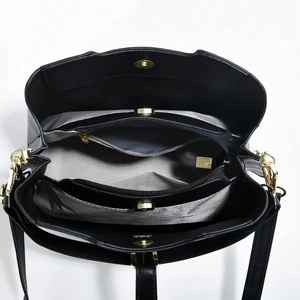 Internal view of black leather tote bag showing multiple compartments and grey lining