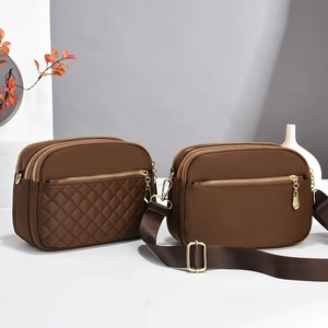 Brown crossbody bags featuring quilted patterns and wide straps in a warm interior setting