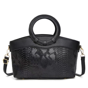 Elegant vintage black leather handbag with snake pattern texture and gold circular handles