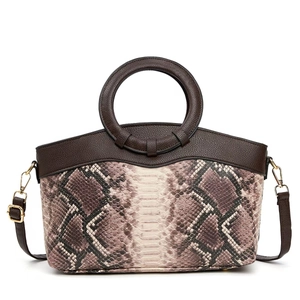 Detail of elegant snake pattern texture with leather round handle and gold hardware