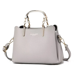 Light gray pebbled leather large tote with golden ring handles and adjustable shoulder strap