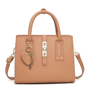 Front view of salmon pink leather handbag with lychee texture and heart charm accessories