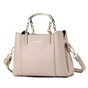 Modern beige leather wedding handbag with gold metal handles and textured litchi finish