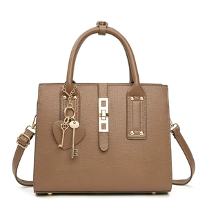 Macro detail of brown litchi pattern bag with gold hardware and heart key charms