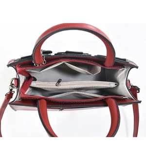 Detail view of red tote bag interior featuring grey herringbone lining and zipper pocket
