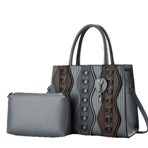 Chic grey leather tote bag set with rivet accents and vintage key charm detail