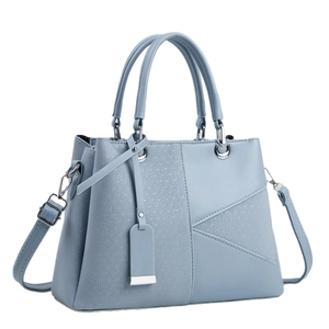 Light blue faux leather handbag with woven texture and adjustable shoulder strap