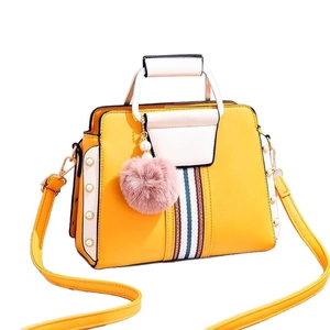 Chic yellow and white contrast women's handbag with stripe ribbon and plush pom charm