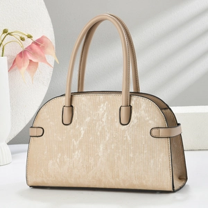 Detail of minimalist beige handbag showing vertical texture and black edge finish