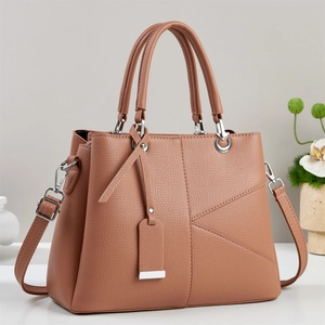Elegant tan lychee grain handbag with shoulder strap and chic geometric stitching
