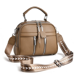 Fashionable khaki leather crossbody bag with silver zippers and geometric wide strap