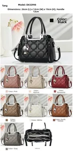 Detail view of large capacity quilted handbag with shell star charm and multi-pocket interior