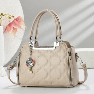 Quilted floral beige leather tote bag with pearl star charm and shoulder strap