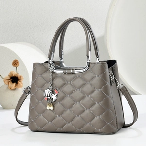 Dark grey quilted handbag with lychee pattern and starfish charm in a modern setting