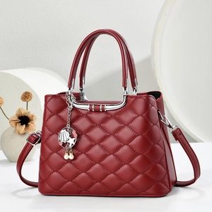 Deep red quilted handbag with silver metal handle and decorative charm detail