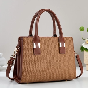 Brown leather woven tote handbag with dual handles and adjustable shoulder strap
