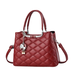 Elegant wine red quilted handbag with metal top handle and pearl shell charm accessory