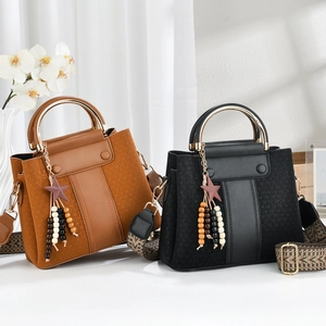 Detail of luxury tote bags featuring woven leather, gold handles, and ethnic straps