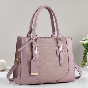Elegant lavender faux leather handbag with textured panel and adjustable strap