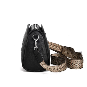 Detail of black lychee grain leather crossbody bag with ethnic jacquard wide strap