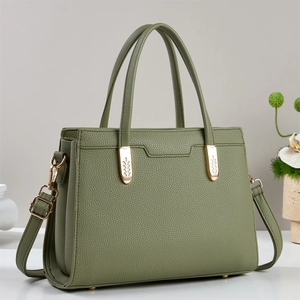 Pea green lychee pattern leather tote bag with gold leaf-textured hardware accents