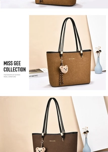 Detail of dark brown matte tote bag with black straps and a cute plush bear pendant