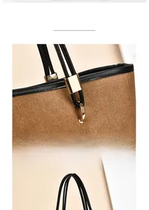 Close-up of brown woven fabric tote with black leather trim and gold-plated hardware