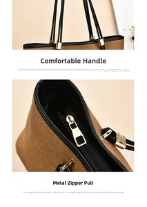 Detail of premium brown tote bag with smooth leather handles and polished gold zippers