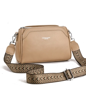 Beige lychee pattern leather crossbody bag with geometric jacquard strap for women