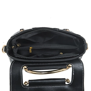 Interior view of black leather handbag featuring golden hardware and multiple compartments
